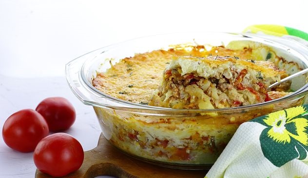 Potato casserole with minced meat, tomatoes, cheese and cream sauce