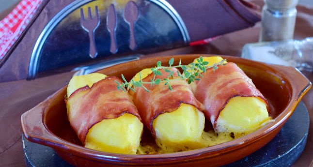 Baked potato with cheese wrapped in bacon