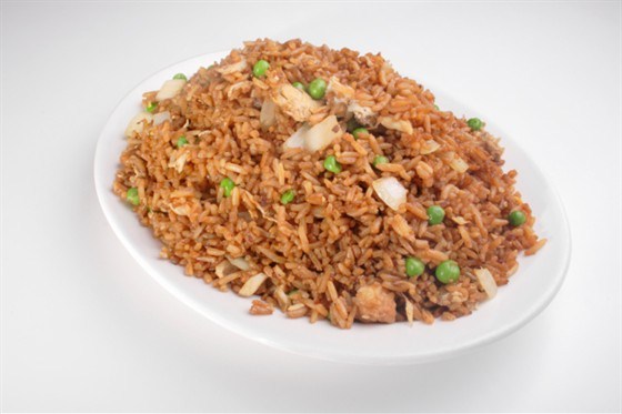 Red rice with spices, chicken and green peas
