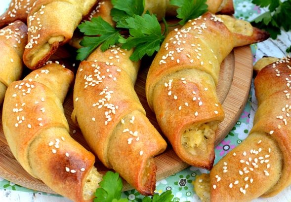 Potato dough rolls with sausage, cheese and herbs