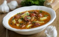 Spanish soup with hunting sausages in chicken broth