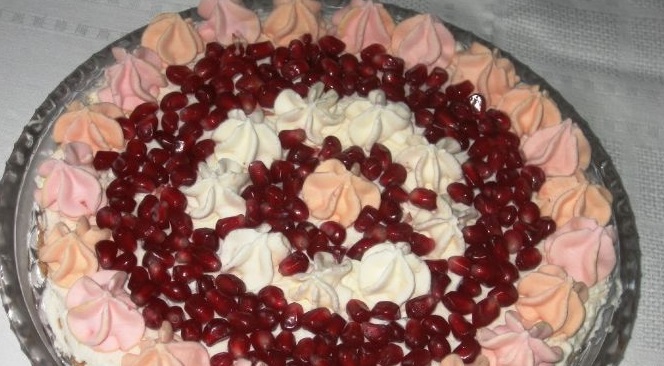 Meringue cake with cream and pomegranate