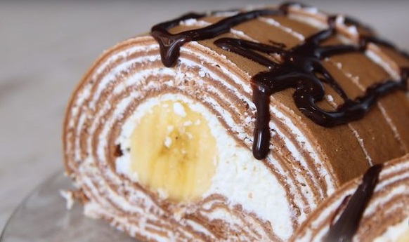 Roll of chocolate pancakes with cottage cheese and banana