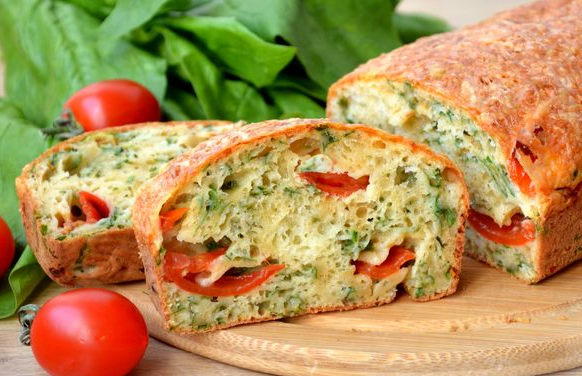 Snack cake with cherry tomatoes, spinach and cheese