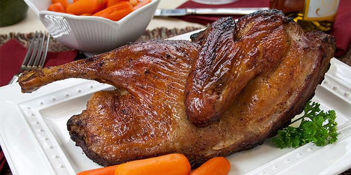Grilled duck stuffed with orange and celery