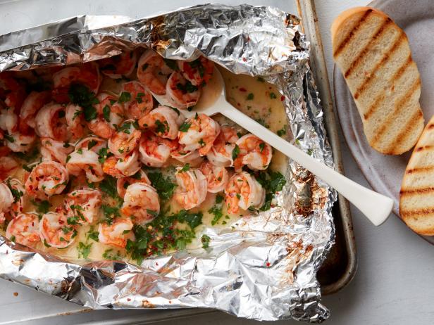 Grilled scampi shrimps in a foil bag Source