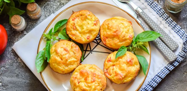 Zucchini muffins with tomato and cheese filling