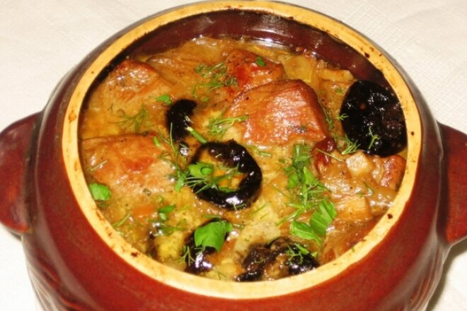 Veal stew with prunes in a pot