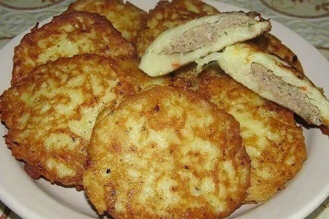 Potato pancakes with minced meat in a pan