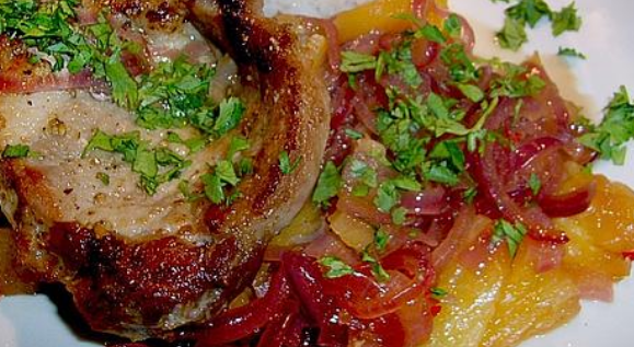 Pork steaks with pineapple, onions and chilli