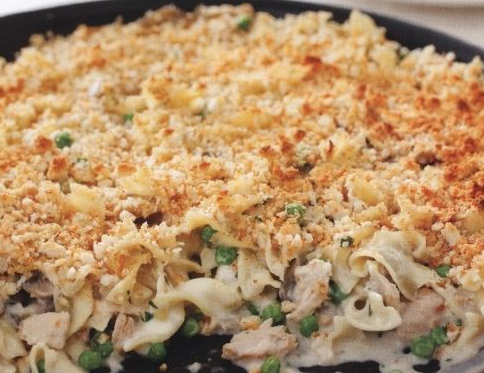 Pasta baked with mushrooms, tuna and cheese in a pan
