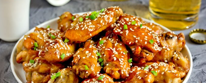 Fried chicken wings in soy-beer glaze