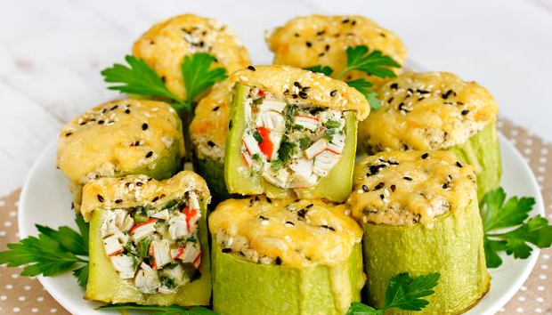 Zucchini stuffed with crab sticks and herbs, baked with sour cream and cheese