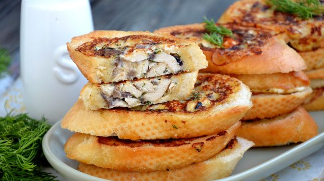 Hot stuffed sandwiches with chicken and mushrooms (in a pan)