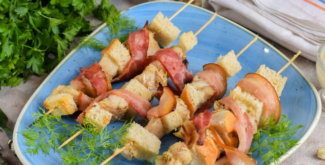 Pollock baked with bacon and bread on skewers
