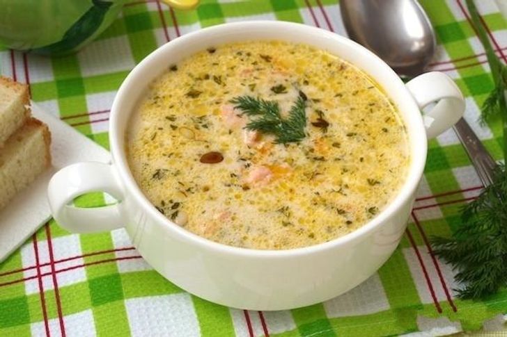 Cheese soup with salmon and pine nuts