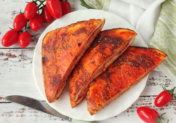 Sandwiches with sausage, cheese and tomato paste, in a frying pan
