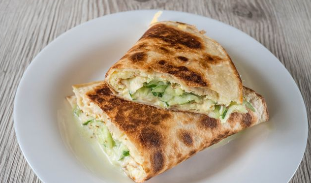 Quesadilla with scrambled eggs, fresh cucumber and cheese