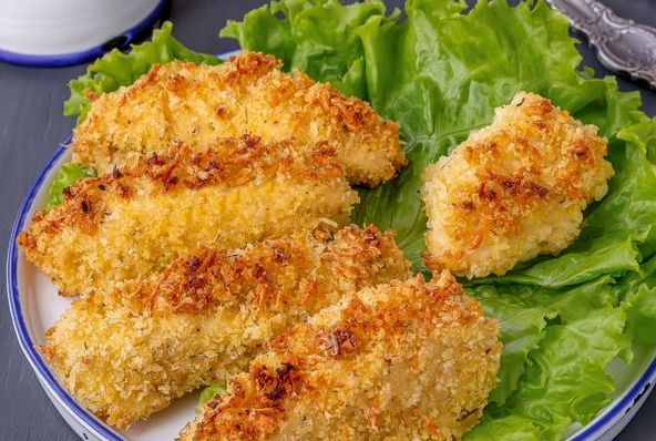 Baked chicken fillet breaded with breadcrumbs and cheese