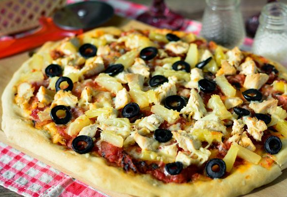 Pizza with chicken, pineapples and olives, yeast dough