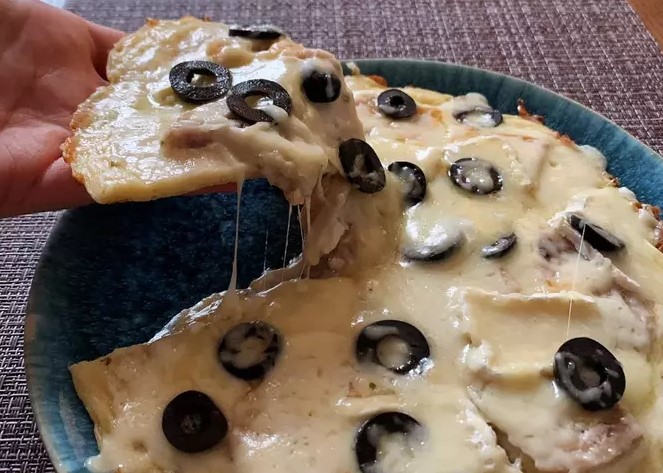Creamy pizza with brie cheese and chicken in a pan