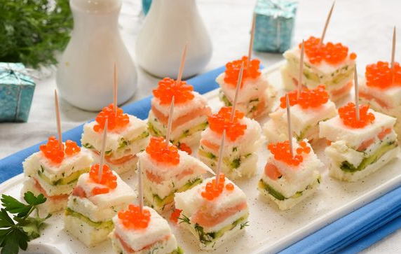 Canape with curd cheese, avocado, red fish and caviar