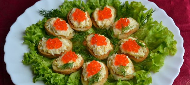 Canape with red caviar and cheese salad