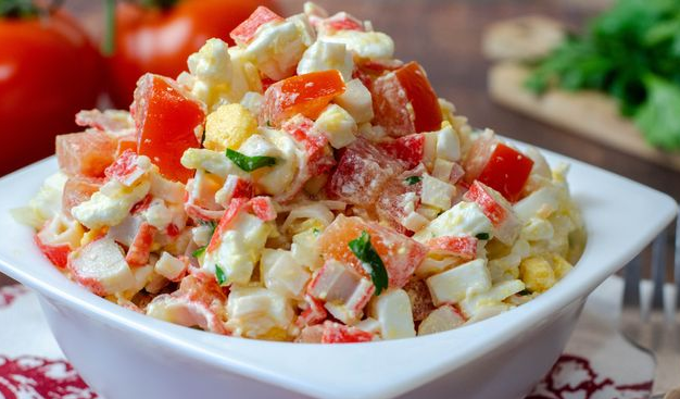 Salad with crab sticks, tomato, cheese and eggs
