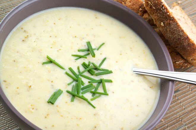 Mushroom soup with melted cheese and herbs