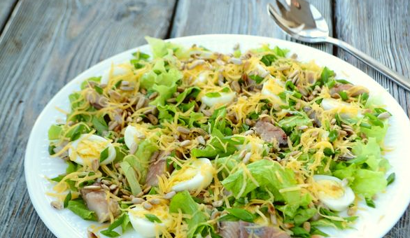 Salad with herring, cheese and quail eggs