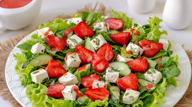 Salad with strawberries, cucumbers, spinach and feta cheese
