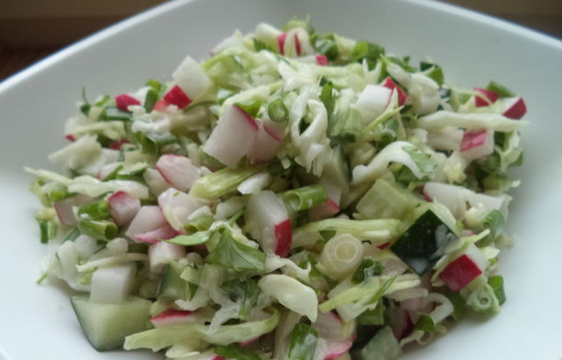 Salad of white cabbage, cucumbers and radishes