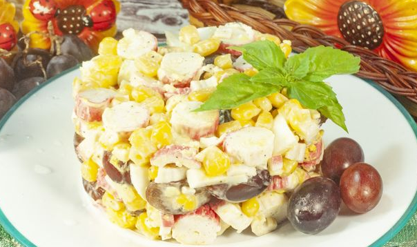 Salad with crab sticks, corn and grapes