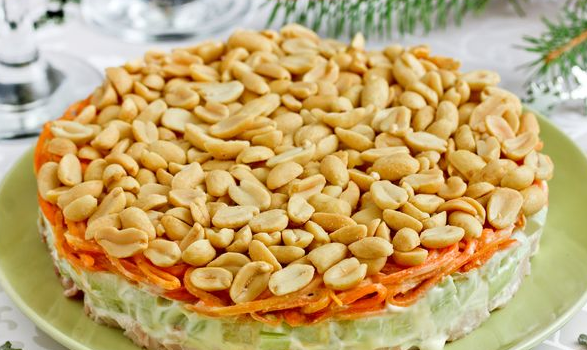 Layered salad with smoked chicken, cucumber, Korean carrots and peanuts