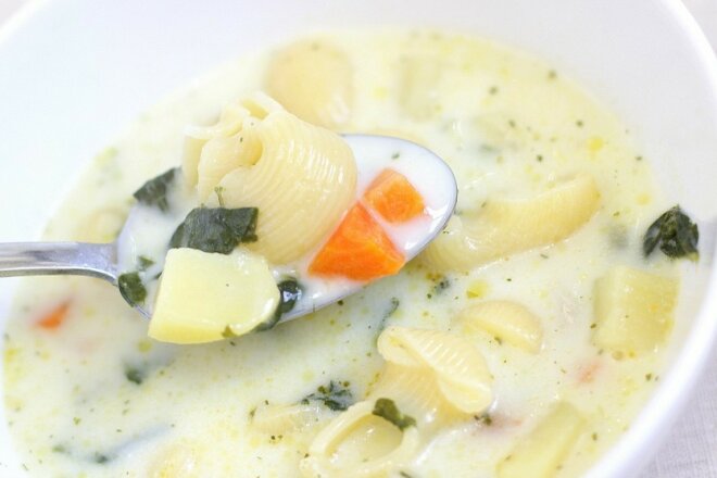 Cheese and milk soup with pasta and vegetables