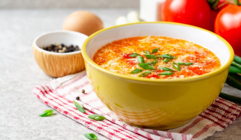 Light chicken soup with eggs and tomatoes