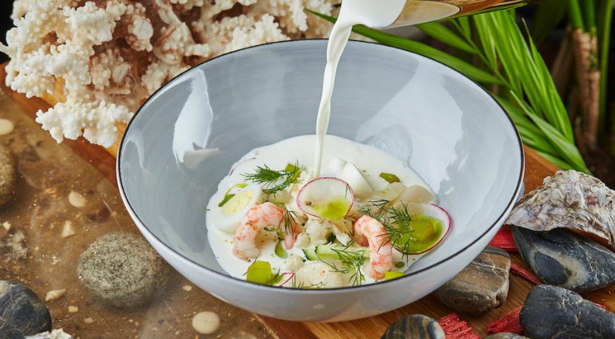 White okroshka with scallop, shrimps and smoked cod
