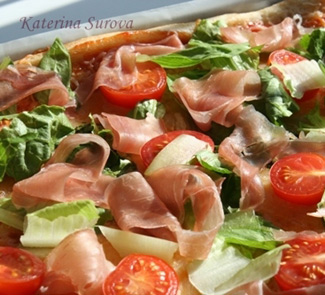 Pizza with salad and prosciutto