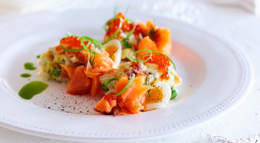 Russian salad with smoked salmon and spicy dressing