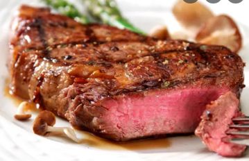 Pork steak on a frying pan