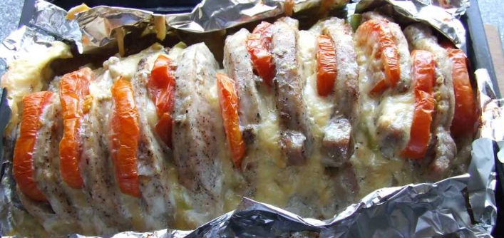 Extremely tender baked pork with cheese and tomatoes