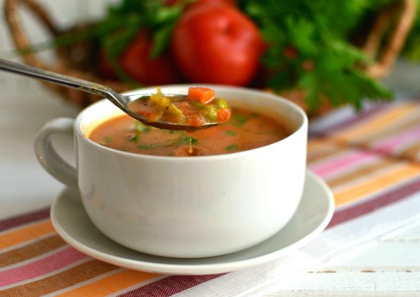Tomato soup with vegetables and melted cheese