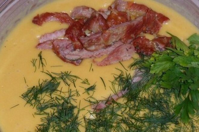 Potato soup with smoked meats and melted cheese