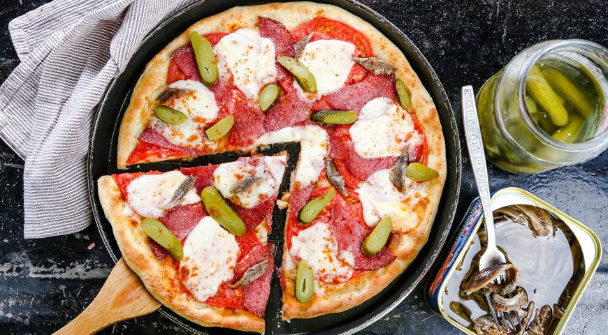 Pizza with pickled cucumbers and sausage