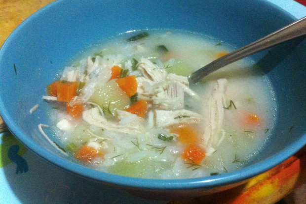 Chicken soup with wild rice and melted cheese
