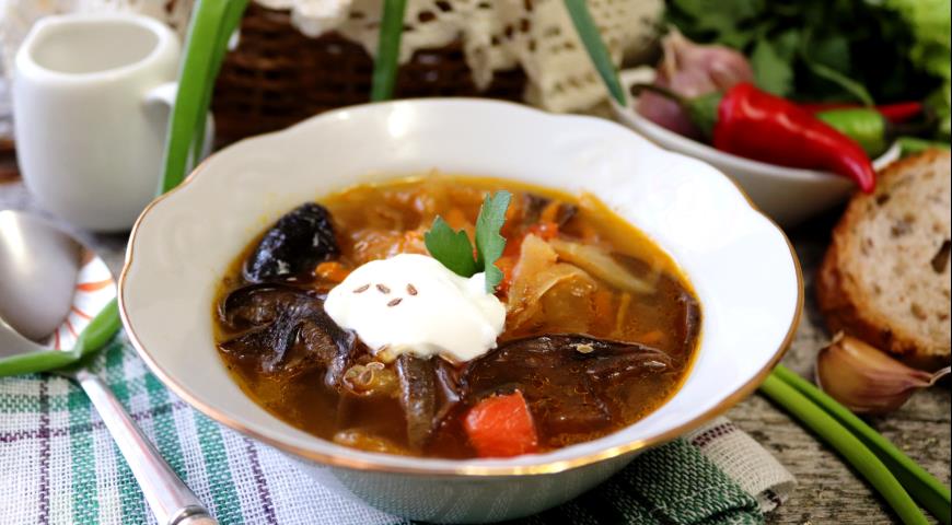 Sauerkraut cabbage soup with dry mushrooms and prunes