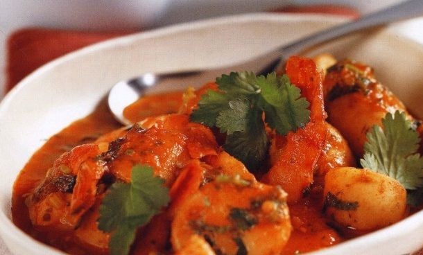Potatoes stewed with shrimps in a spicy tomato sauce