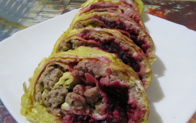 Omelet roll with meat and beets