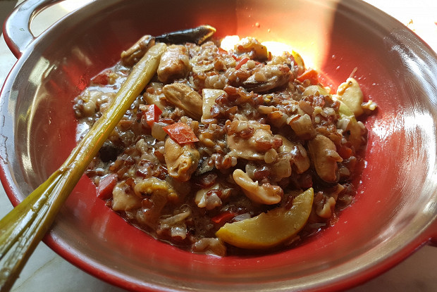 Red rice in coconut milk with seafood and vegetables