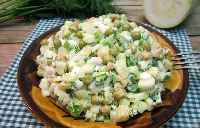 Pickled zucchini salad with potatoes, eggs and green peas